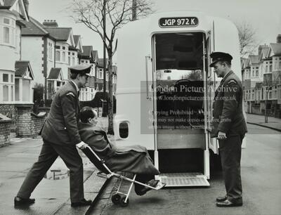  Ambulance men assisting a patient 