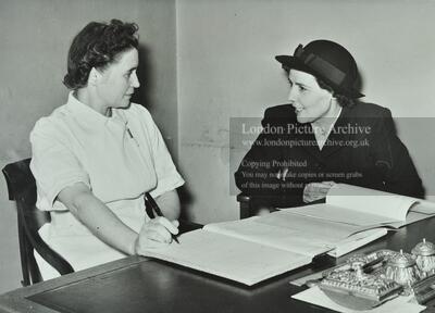 Health visitor interviewing the matron of a day nursery 